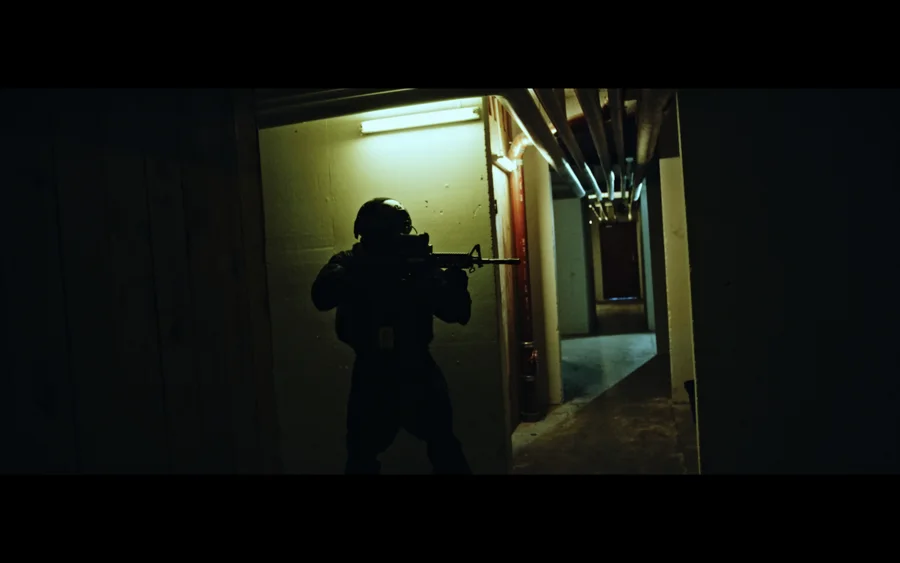 Gadens Melodi — A tactical character in a dimly lit corridor