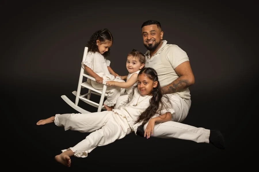 Omid Romal with his three daughters in a family portrait