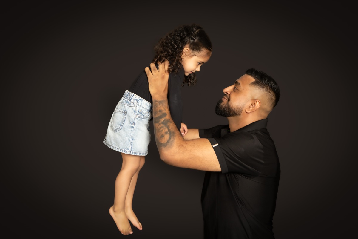 Omid holding his daughter during a family portrait session