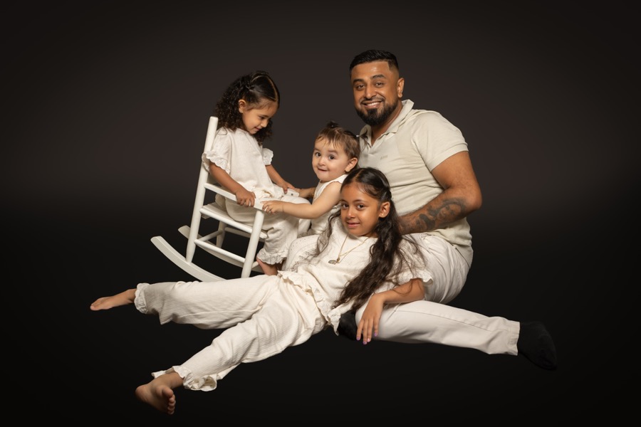 Omid with his three daughters in a family portrait
