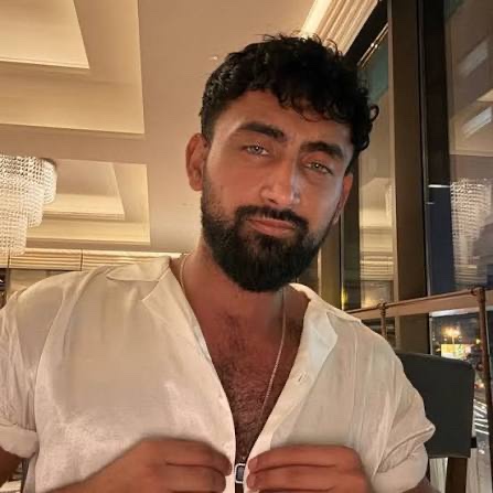 Ryan Romal wearing a white shirt